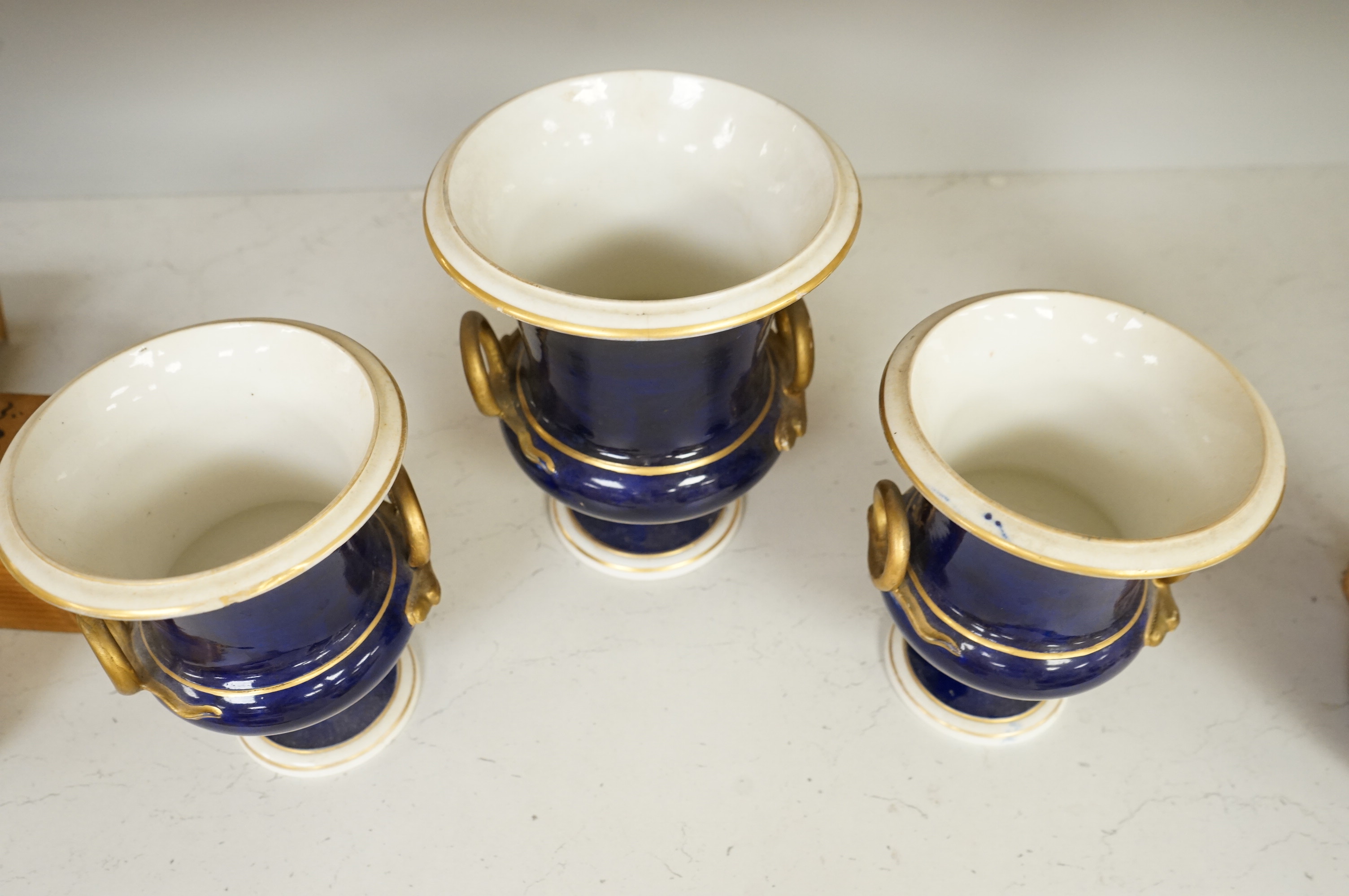 A set of three Derby campana vases, painted with named views, circa 1820, tallest 20.5cm